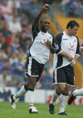 Jermain Defoe is assisted in celebrating his goal at Portsmouth by Andy Reid