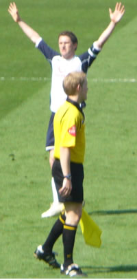 Spurs Player of the Season Robbie Keane celebrates in front of the ecstatic away support after scoring his goal at Higbury in April. The assistant referee has seen Lehmann making a bee line for Edgar Davids. This picture is courtesy of Gerry and Jenny Taylor