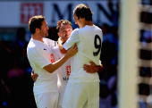 Goal-scorers Robbie Keane and Dimitar Berbatov celebrate with Steed Malbranque who laid on the second goal